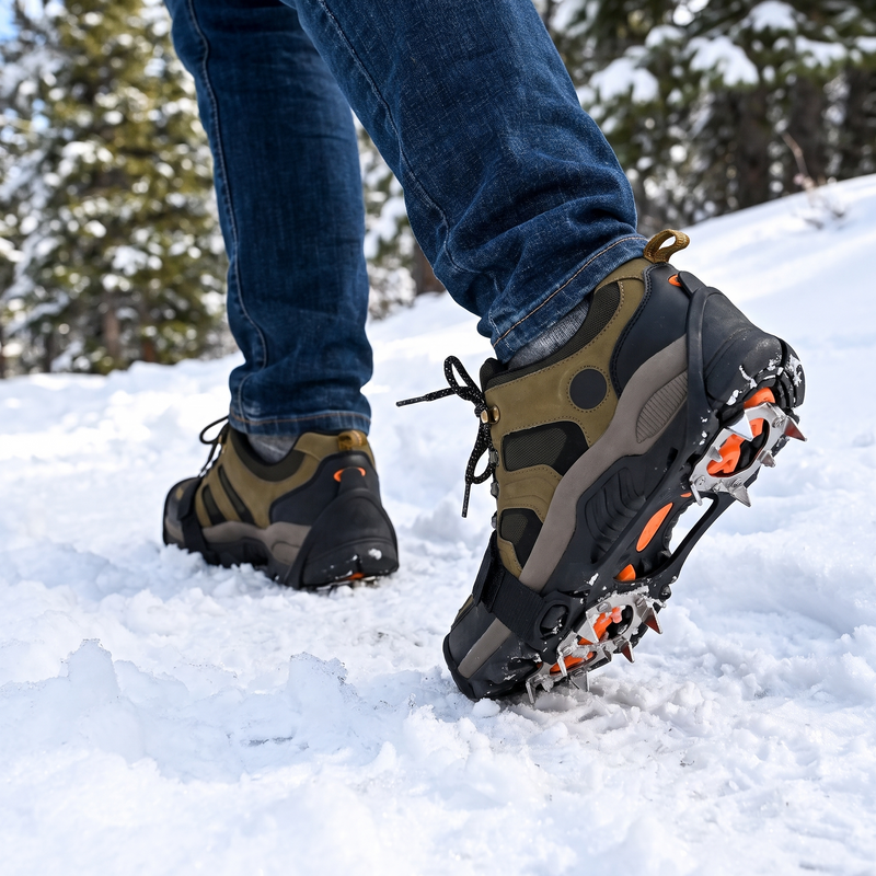 Hiking boots with ice traction crampons walking on snow