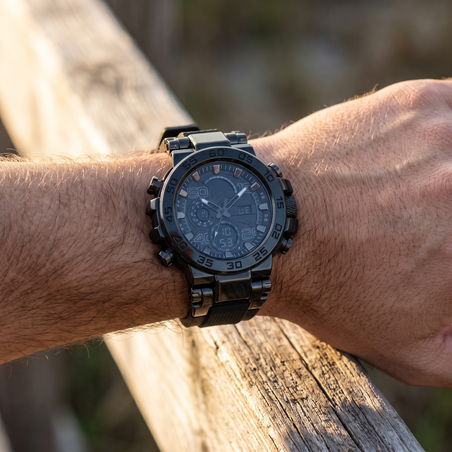 Round black tactical watch worn on the wrist resting on a wooden rail