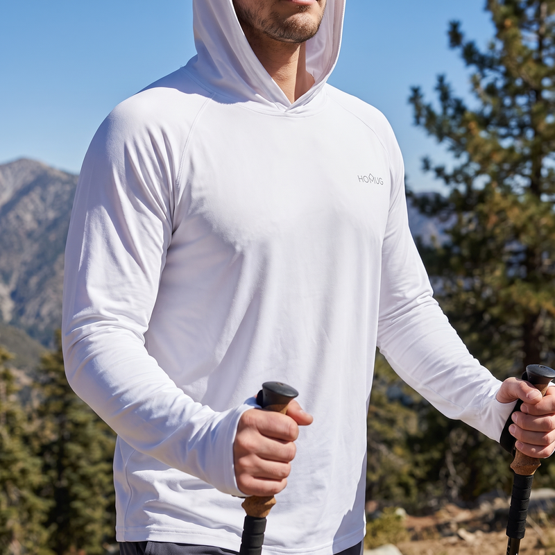 Man wearing hooded UPF sun shirt hiking sunny trail