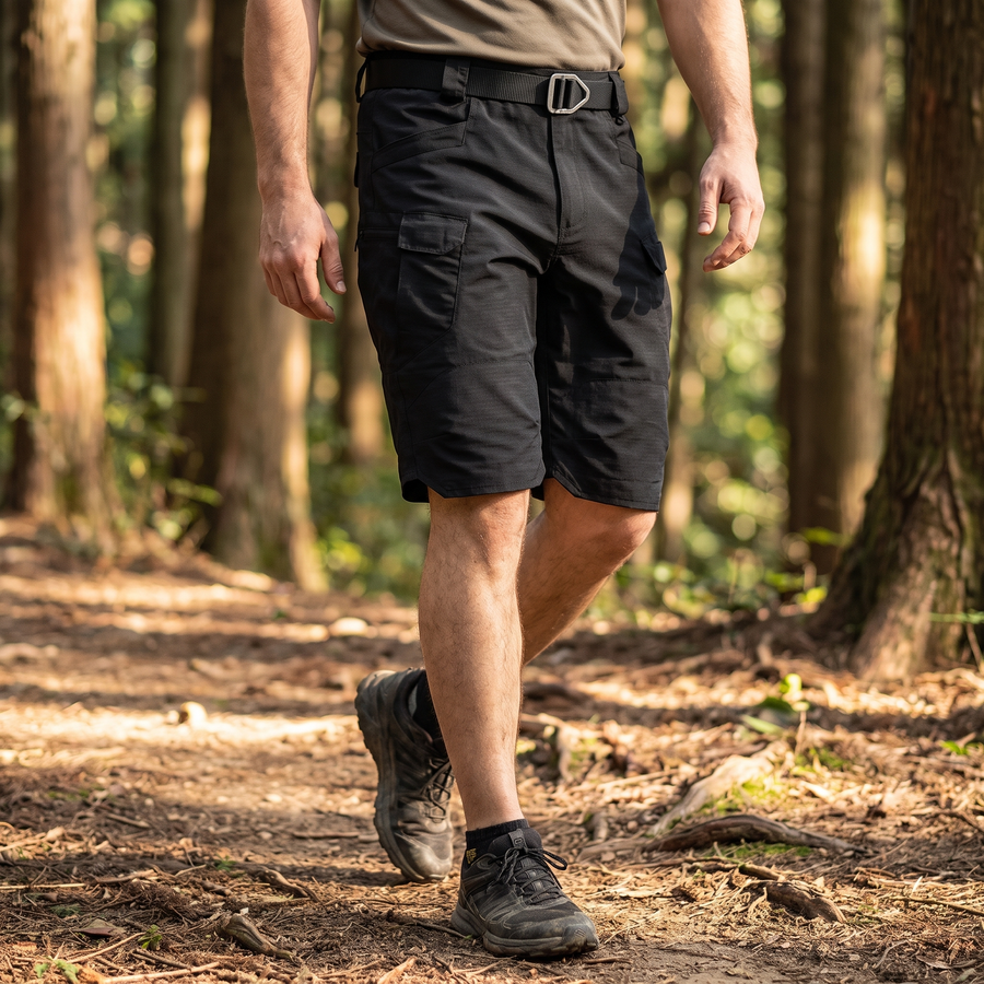 Hiker on a forest trail wearing the black TactixGuard Pro tactical shorts with D-ring belt
