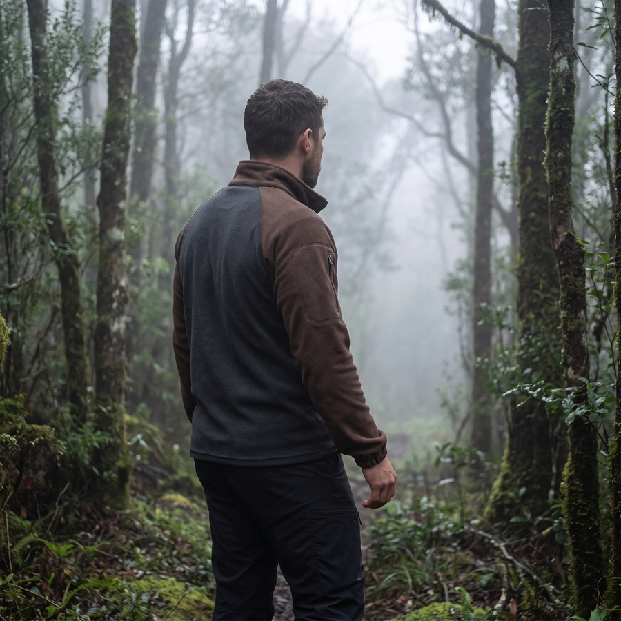 Man on a misty forest trail in the two-tone fleece pullover