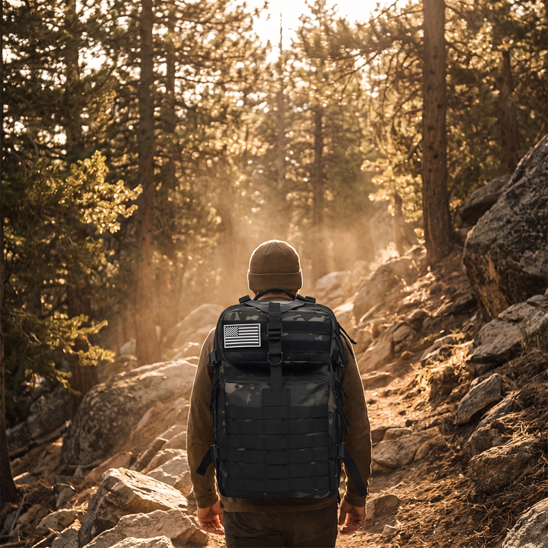 Hiker wearing waterproof tactical backpack on a mountain trail